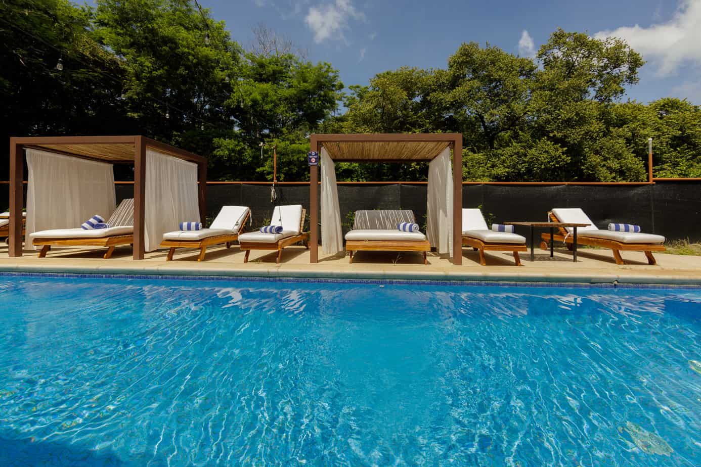 Poolside cabanas and lounge chairs.