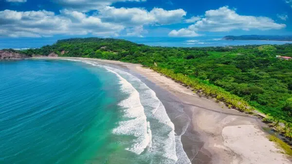 Tropical beach with turquoise water and waves.