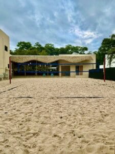 Outdoor sand volleyball court with net.