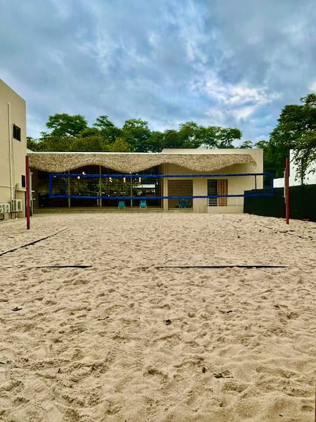 Outdoor sand volleyball court with net.